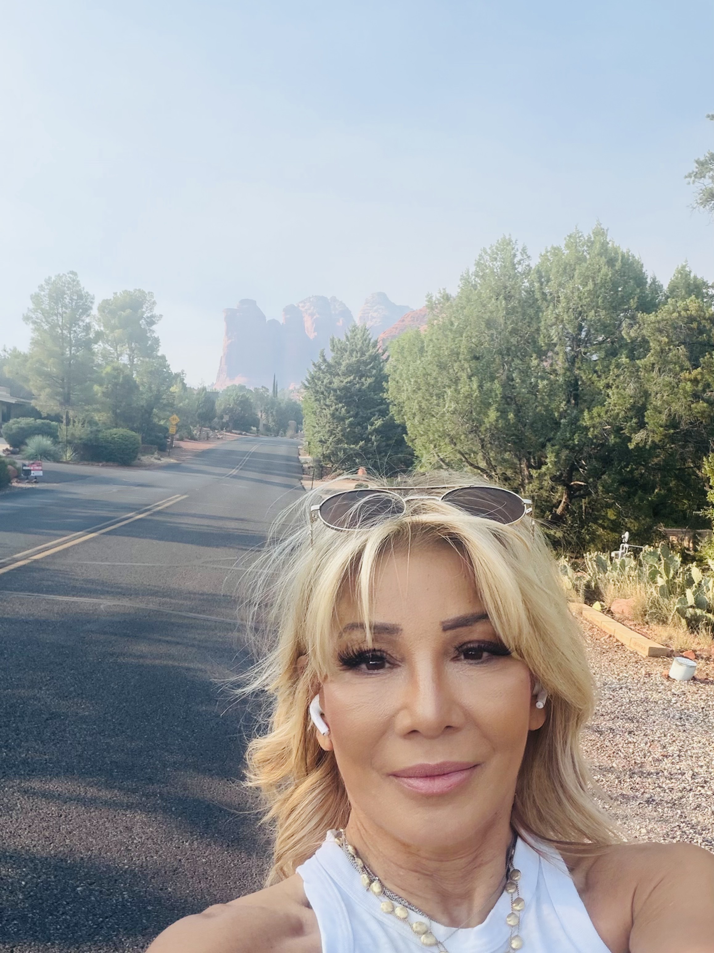 Kim Fisher on a morning walk with red rock mountains in the distance