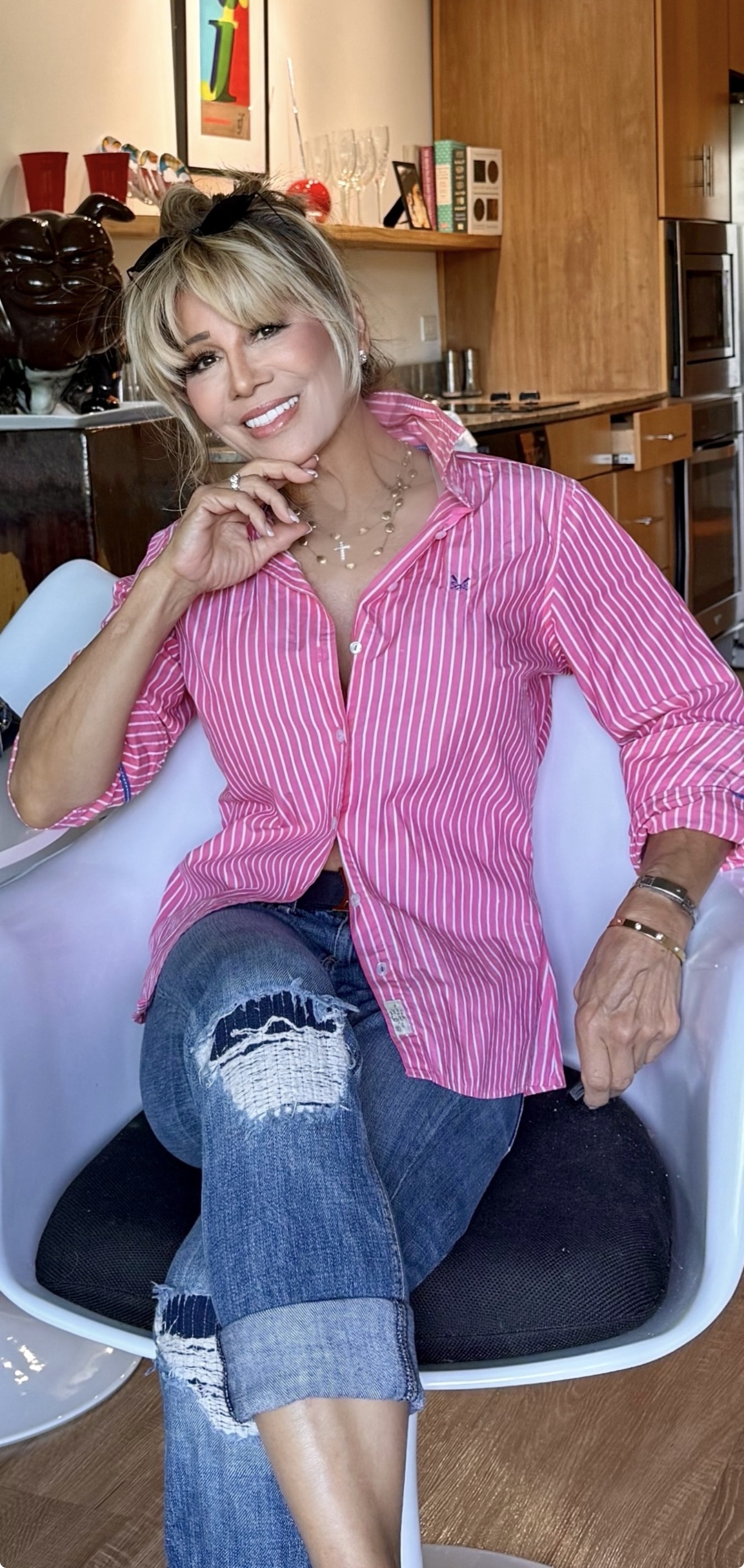 Kim Fisher at home in a pink striped shirt, mid-conversation, telling the story of the first cohort