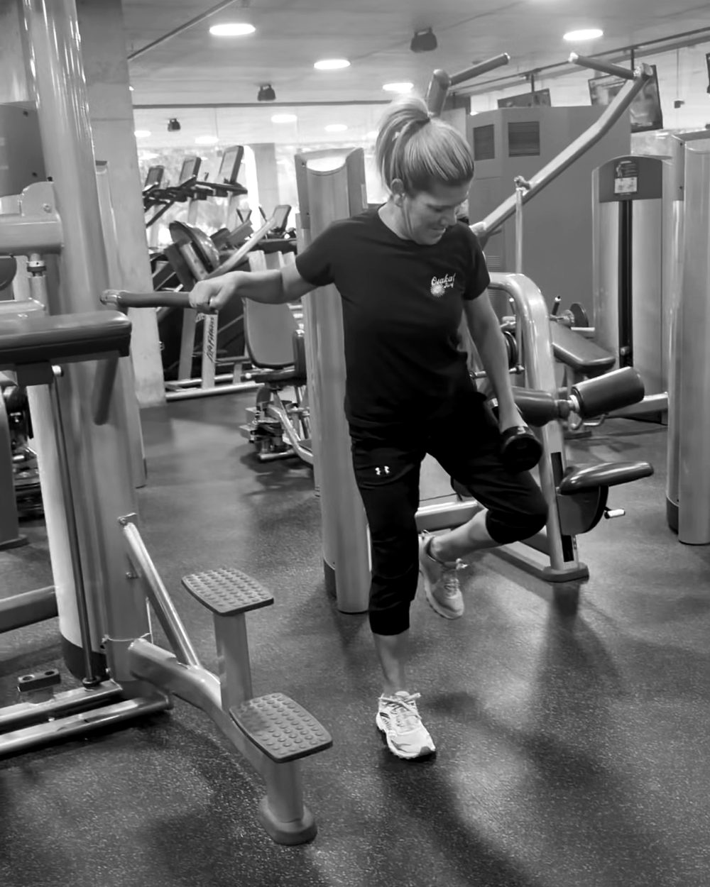 Michelle learning a new single-leg exercise with a dumbbell