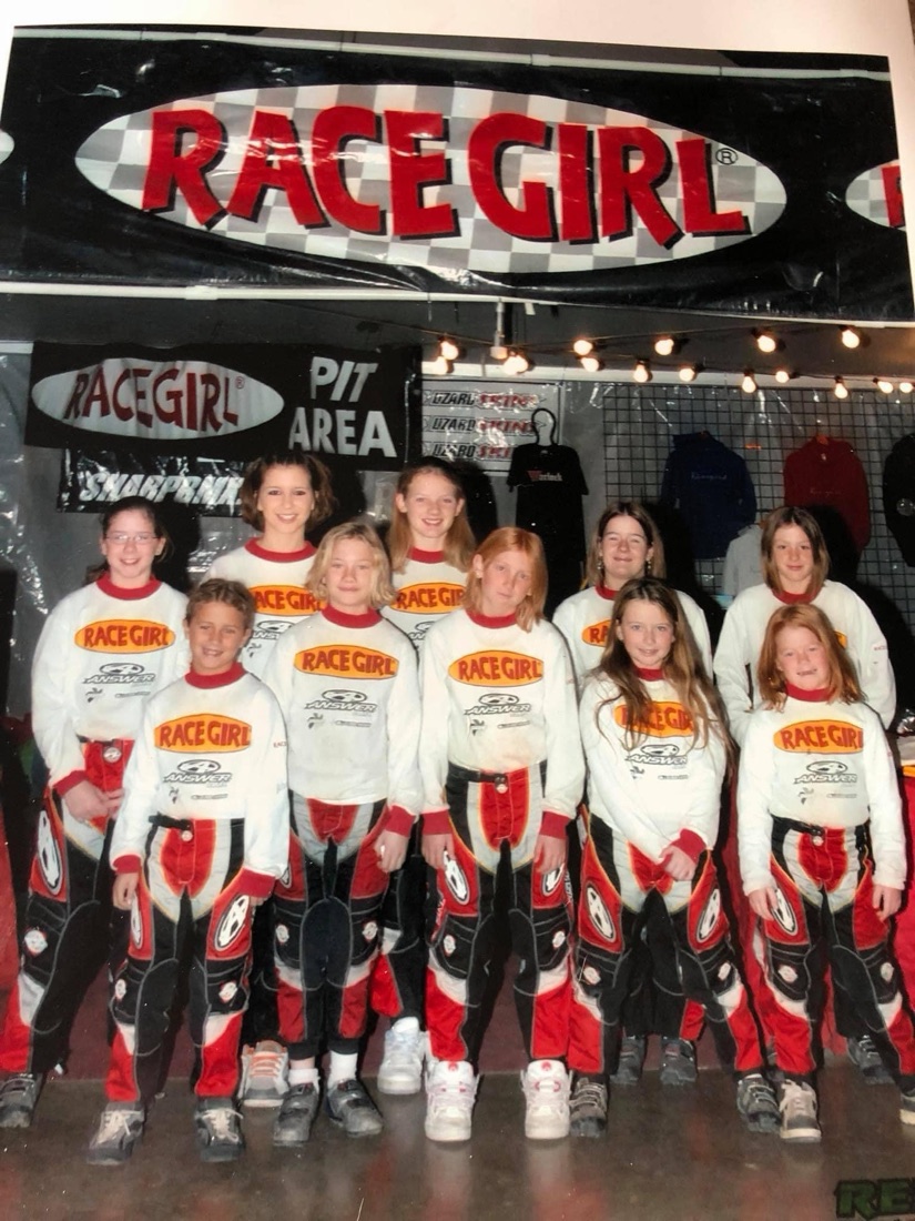 The Racegirl BMX League team in Racegirl and Answer racing kit, standing together in the Racegirl pit area